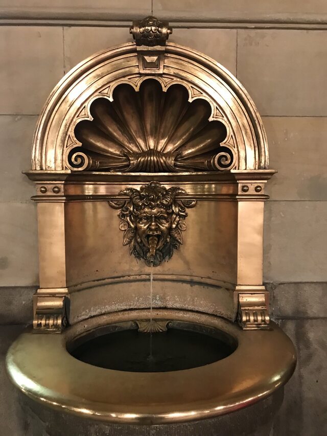 A small fountain in the form of a demon's head in the building of the Rathaus